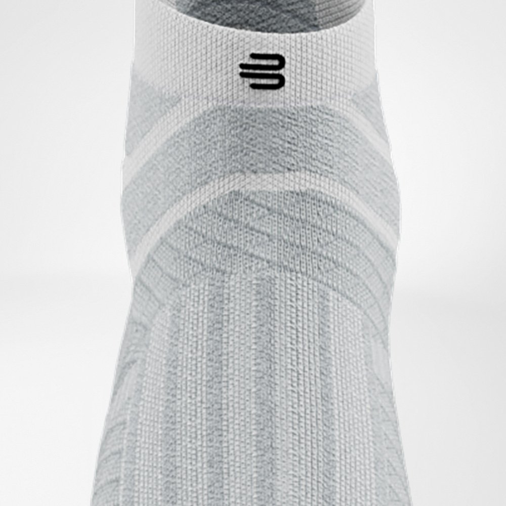 Dinamica e comfort in bianco Calza bianca Run Performance Low Cut di Bauerfeind in vista frontale, con struttura evidente sul collo del piede e polsino elastico.