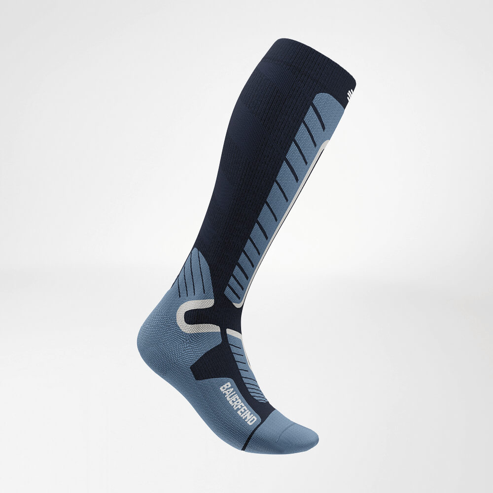 Vista laterale di un calzino a compressione da sci blu fino al ginocchio, con motivo a maglia rinforzato per massimo supporto e comfort durante lo sci.