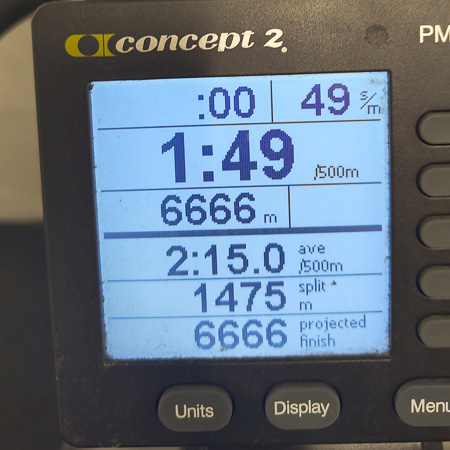 6666 metri sullo SkiErg – il sudore non mente! Primo piano di un monitor da allenamento SkiErg. Lo schermo mostra una distanza di 6666 metri, un tempo medio di 2:15 per 500 metri e un tempo di 1:49 per 500 metri.