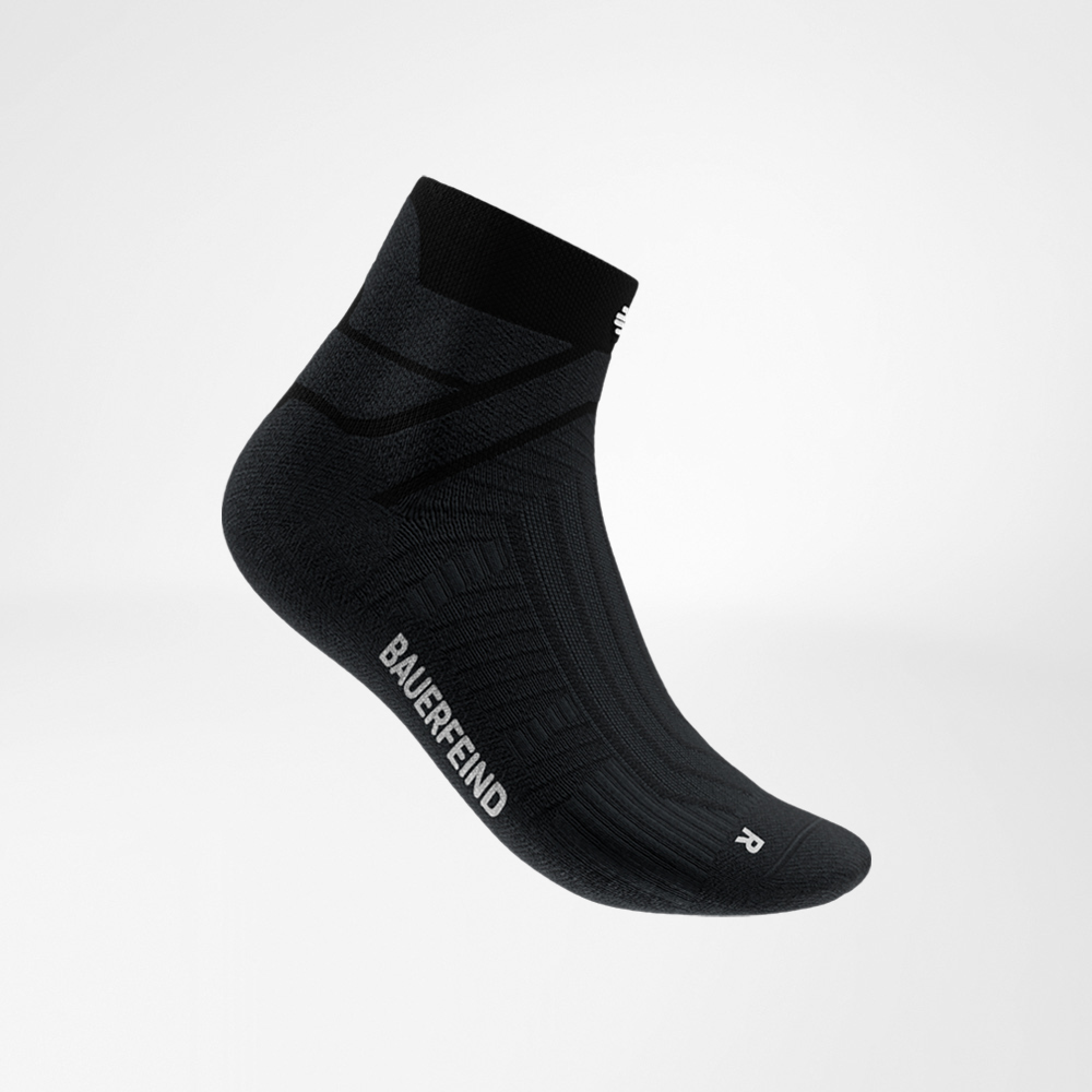 Calza nera Run Performance Low Cut di Bauerfeind in vista laterale, con focus sulla zona del collo del piede, la struttura traspirante e la scritta Bauerfeind sul lato.
