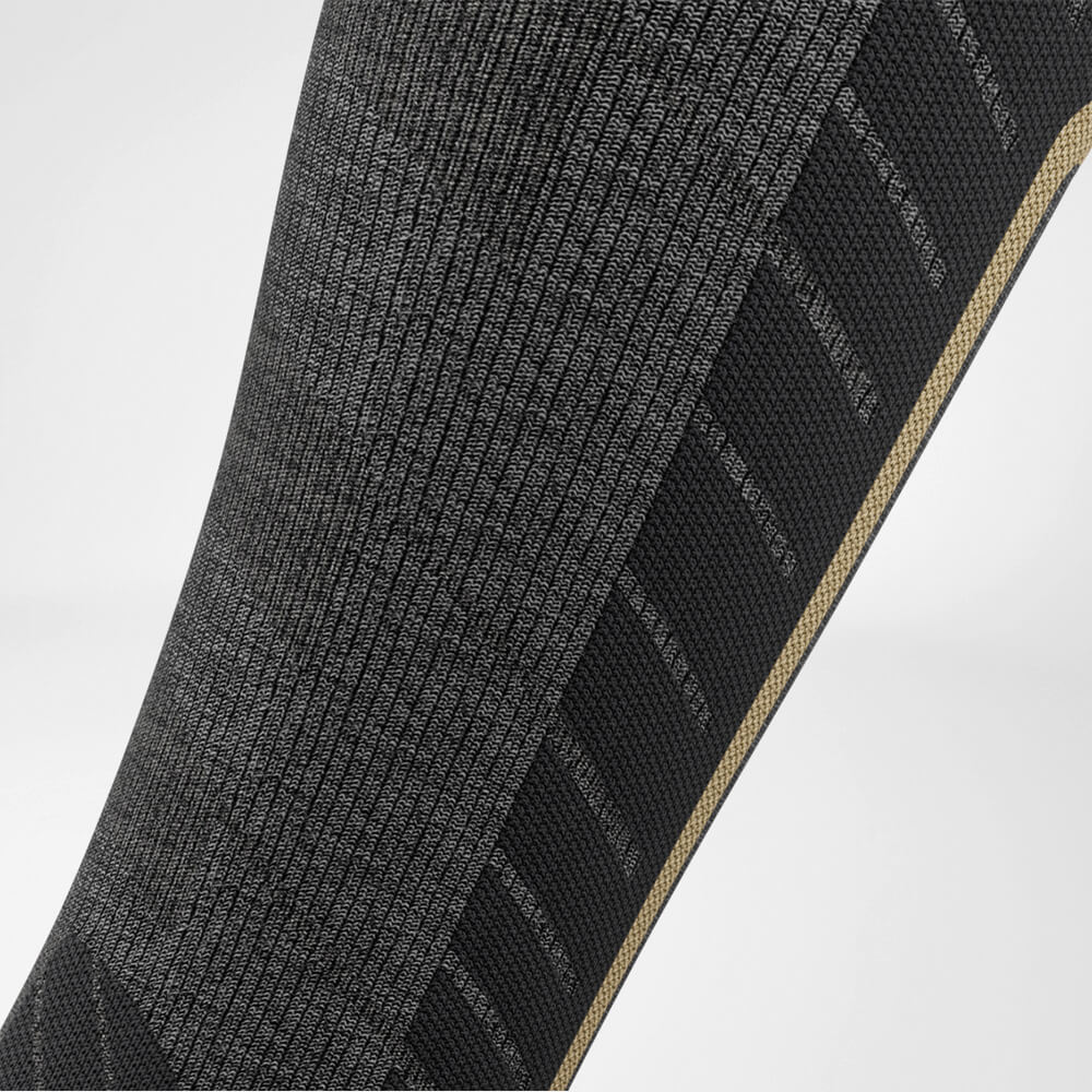 Calzino da sci da discesa con lana merino grigio dettaglio zona di compressione Vista dettagliata della zona di compressione del polpaccio della calza sportiva grigia da sci con lana merino