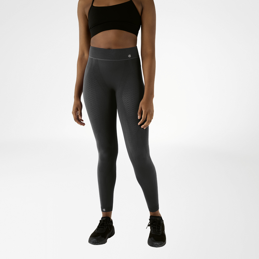 Donna con reggiseno sportivo nero e pantaloncini a compressione alla caviglia color antracite