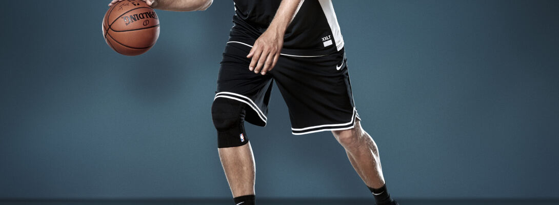 Bendaggio del ginocchio Dirk Nowitzki a Basketball Dribbling Basekballer quando dribbing indossa un supporto per il ginocchio sportivo Dirk Nowitzki Edition